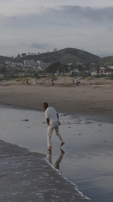 Man Skips Through Shallow Ocean Water Stock Footage 339707027