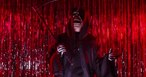 Man in skull mask and grim reaper costume pointing you and saying hush be quiet Stock Footage 313997124