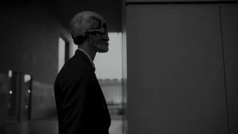 A man with a skull mask looking at something 스톡 동영상 259884718