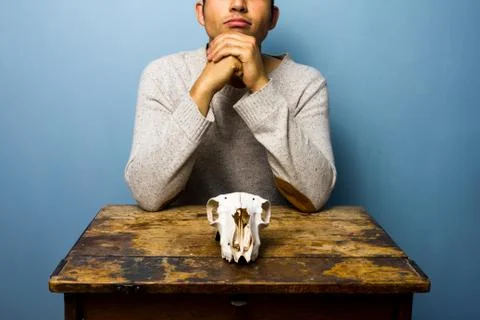 Man with skull is thinking 스톡 사진