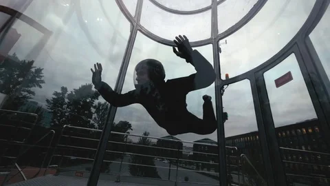 Man skydiver flies in air a wind tunnel slow motion. Extreme parachuting Stock Footage 78884573