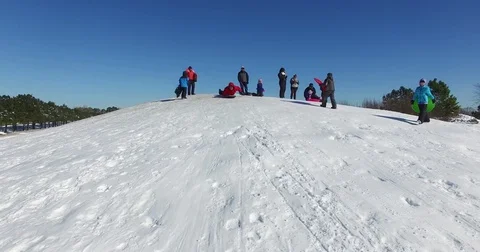 Man Sled Riding Down Hill Stock Footage 84944375