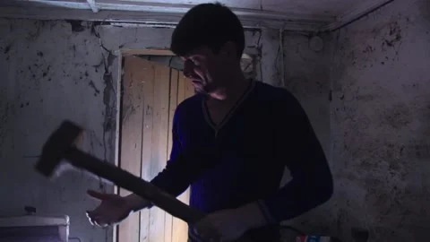 A man with a sledgehammer the old building. Video stock 137970113