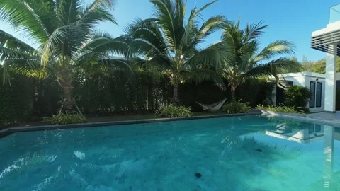 Man Sleep in hammock beside the pool Stock Footage 310683856