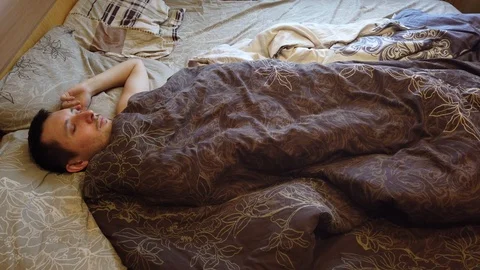 Man sleeping and waking up alone in the bed, close up of face. Headshot of adult Stock Footage 104053057