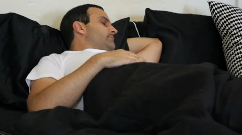 Man sleeping in bed Stock Footage 53200833
