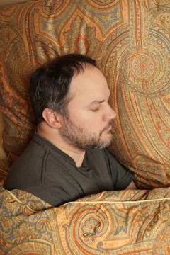 Man sleeping in bed Stock Photos