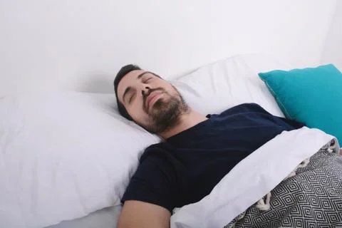 Man sleeping on bed. Stock Photos