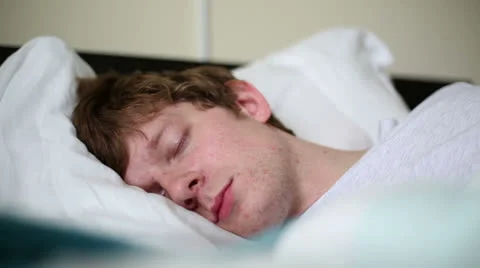 Man Sleeping in Bed Yawns - Close-up Stock Footage 25347459