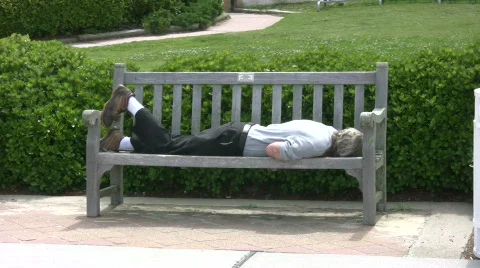 Man sleeping on bench Stock Footage 457381