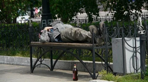 Man sleeping on a bench Stock Footage 7907976
