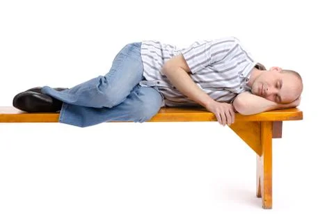 Man sleeping on a bench Stock Photos