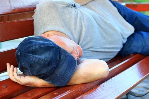 Man sleeping on bench Stock Photos