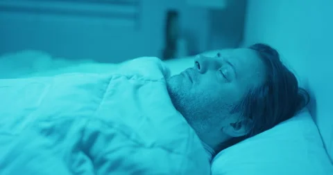 Man sleeping blue lights alien abduction ghost bedroom Video stock 249301911