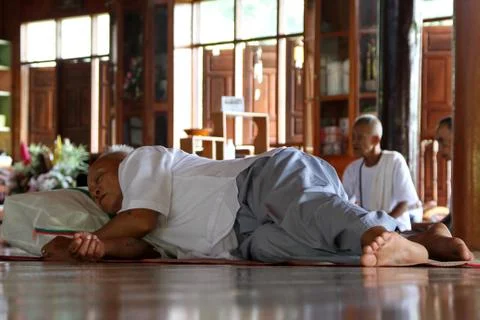 Man sleeping in buddhist temple Stock Photos