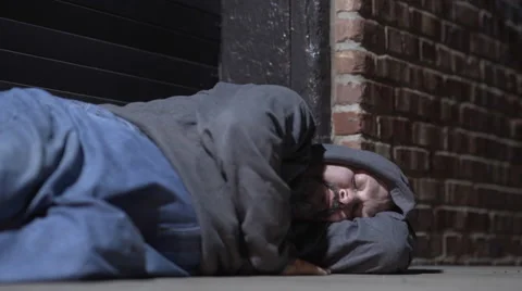 Man sleeping in cold city back streets at night 4k Video stock 68985847