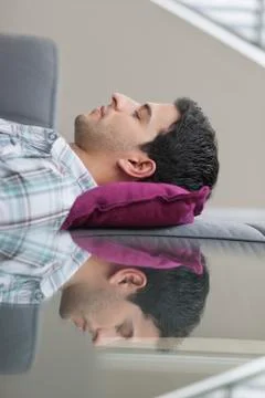 Man sleeping on a couch Stock Photos