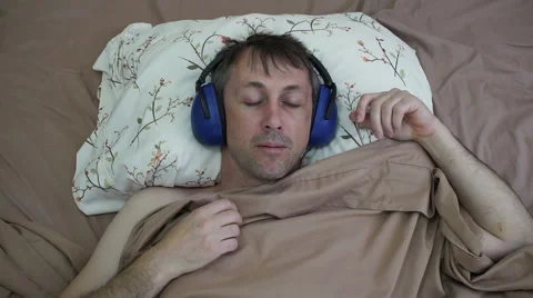 Man Sleeping in Daytime With Earmuffs Stock Footage 64104245