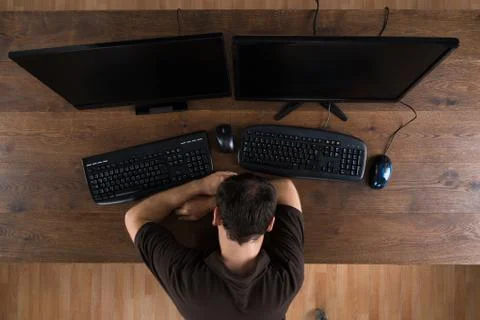 Man Sleeping At Desk With Computers Showing Program Code Photos