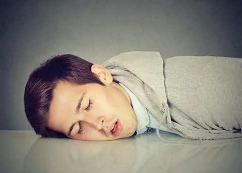 Man sleeping on a desk Stock Photos