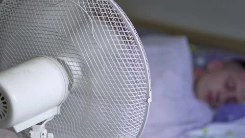 Man sleeping with fan blowing Stock Footage 156588581