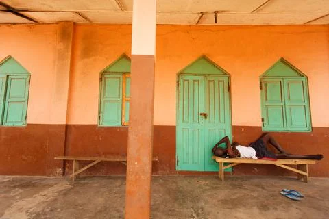 Man sleeping in front of house Stock Photos