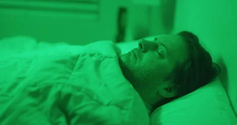 Man sleeping green lights alien abduction ghost bedroom Stock Footage 249301856