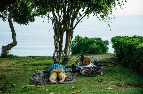 Man sleeping on the lawn Stock Photos