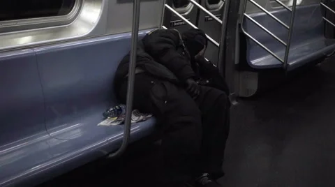 Man sleeping on moving train, homeless guy in New York City 스톡 동영상 60791393