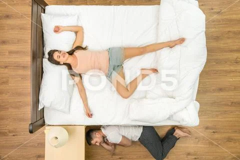 The man sleeping near the bed. View from above Stock Photos