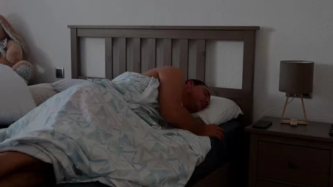 Man Sleeping Peacefully in Bed at Home Covered with Blanket Stock Footage 345639156