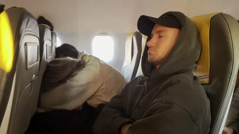 The man is sleeping on the plane, the passenger is sleeping Video stock 256885666