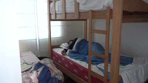 A man sleeping pleasantly in a huddled cabin after a night of alcoholic drinks 库存影片 155817224