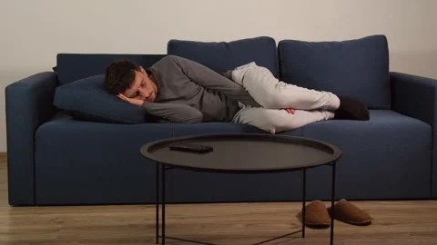 A man sleeping on a sofa Stock-Footage 322566233