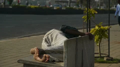 Man sleeping on a street bench Stock Footage 10807713