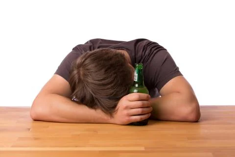 Man sleeping on a table with beer Stock Photos
