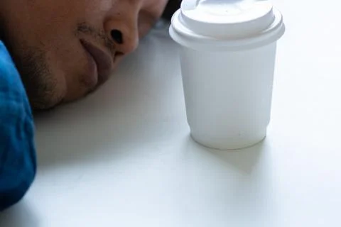 Man sleeping on table, laptop on table, man tired from work Stock Photos