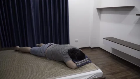 Man sleeping upside down in bedroom Stock Footage 158964154