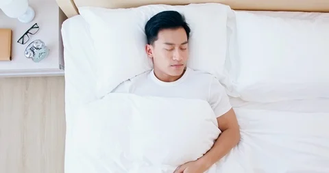 Man sleeping well in bed Stock Footage 121943662