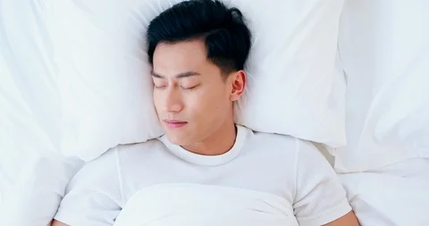Man sleeping well in bed Stock Footage 121944923