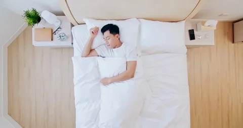 Man sleeping well in bed Stock Footage 122208264