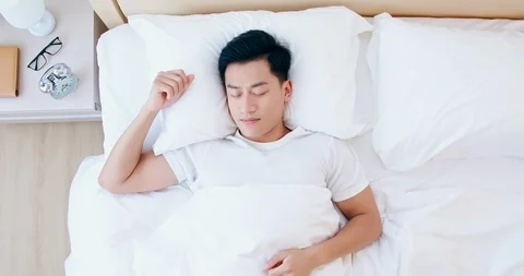 Man sleeping well in bed Stock Footage 122208348