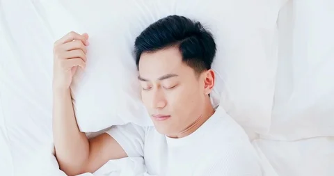Man sleeping well in bed Stock Footage 122722917