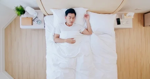 Man sleeping well in bed Stock Footage 122990342