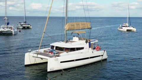 A man sleeps on the bow of a catamaran Stock Footage 258742206