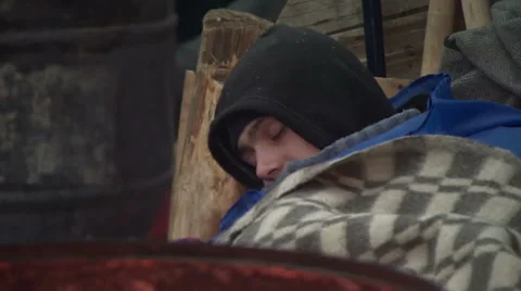 Man sleeps by a campfire on the Central square. Stock Footage 41999370