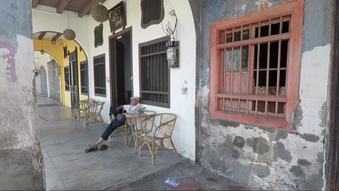 Man sleeps infront of the Guest house inn, George Town, Penang, Malaysia Stock Footage 160888872