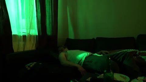 	 A man sleeps on a sofa under a brown blanket. Concept: mental anxiety and inst Stock Footage 299055673