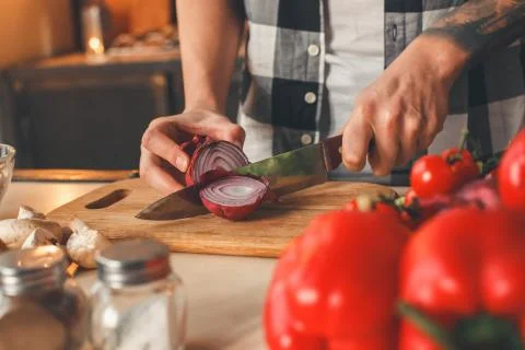 Man sliced violet onion, preparing salad Stock Photos