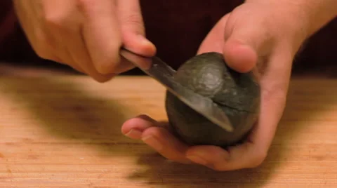 Man Slices an Avocado in Half Stock Footage 62748005